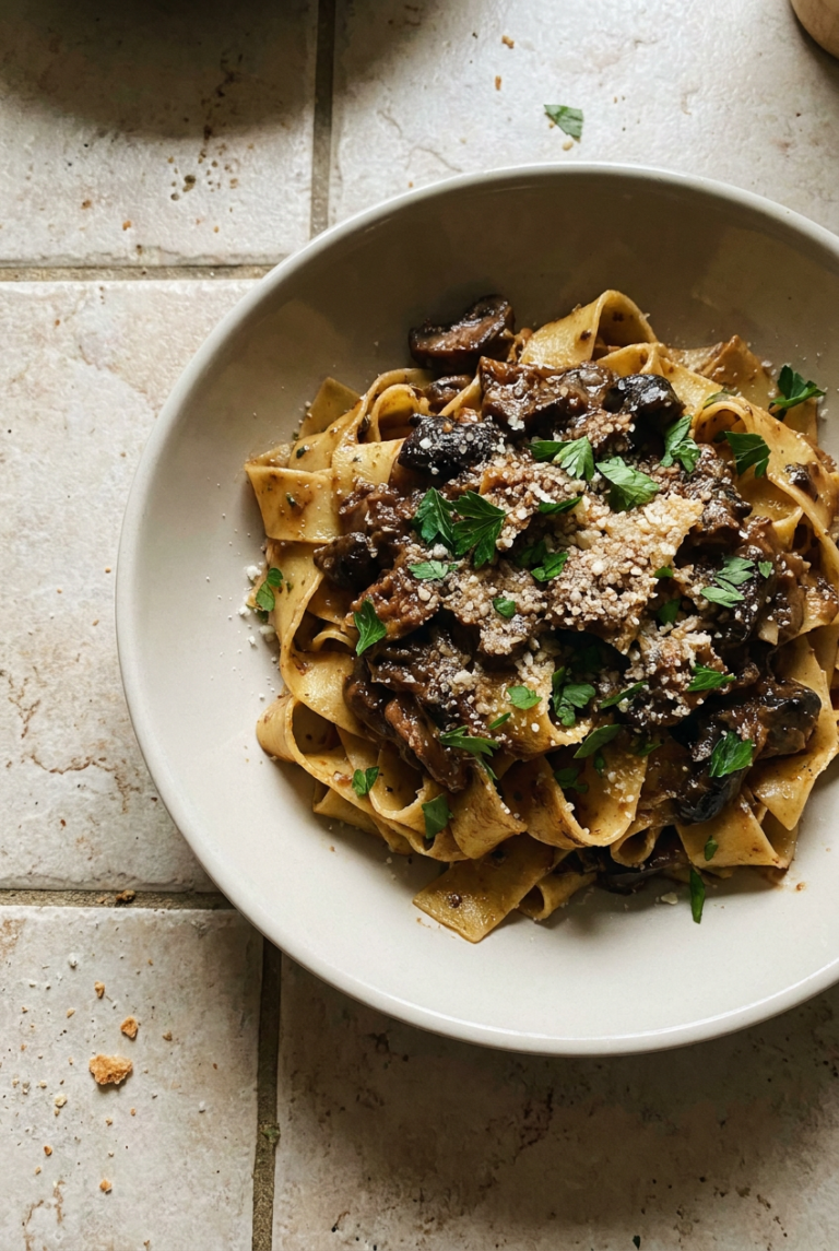 homemade pappardelle with wild mushroom ragù recipe - Homemade Pappardelle with Wild Mushroom Ragù served in a white bowl overhead view